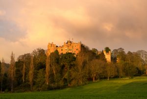 Dunster Castle taken very early on a summer morning with sunrise and stormy clouds an Exmoor landscape