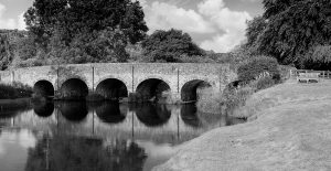Relax at Withypool Bridge Exmoor landscape black and white photo of six arch bride over river barle