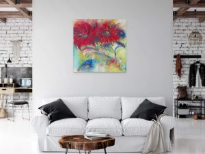 Discover the allure of abstract art with a painting that transforms a modern living space with its vibrant reds and blues, creating a captivating focal point against the minimalist decor